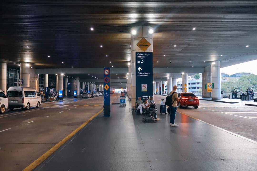 KLIA Terminal 1 arrival pickup lane with door signage