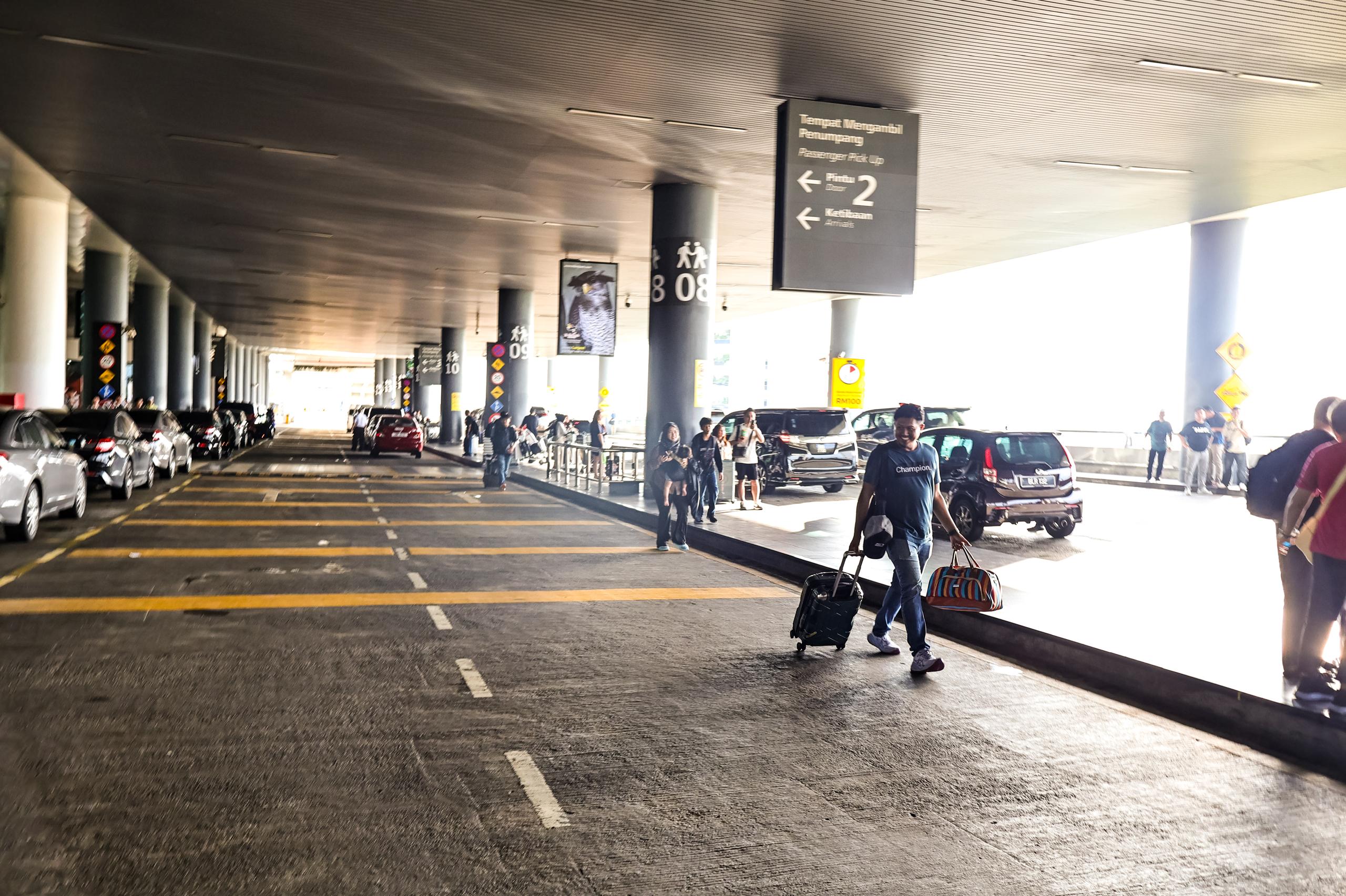 KLIA Terminal 2 passenger pickup lane and door signage